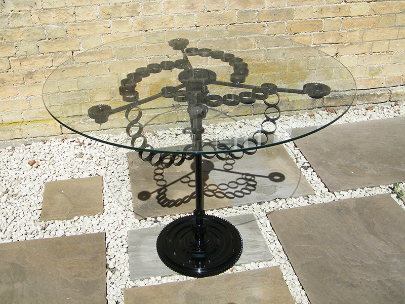 Glass table created from recycled steel